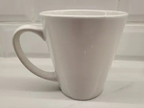White ceramic coffee mug featuring York Jets logo and green accents