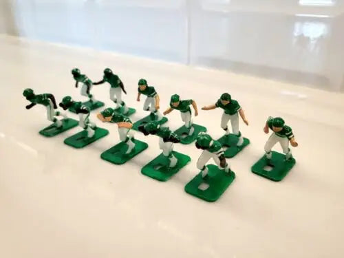 Green and white figurines from Vtg Tudor New York Jets Electronic Football game