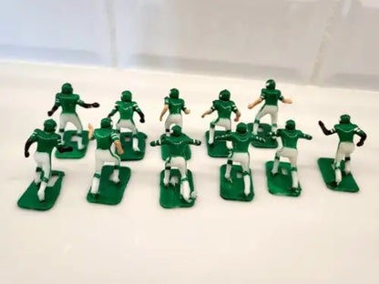 Green and white plastic football figurines from Vtg Tudor New York Jets Electronic Football