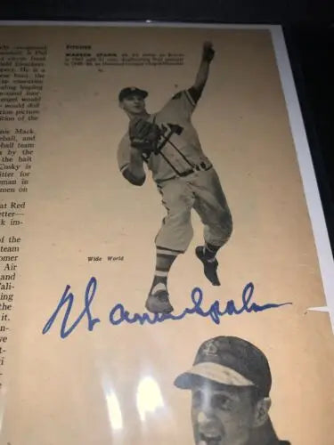 Signed Warren Spahn baseball on sport magazine page from 1950 Boston Braves