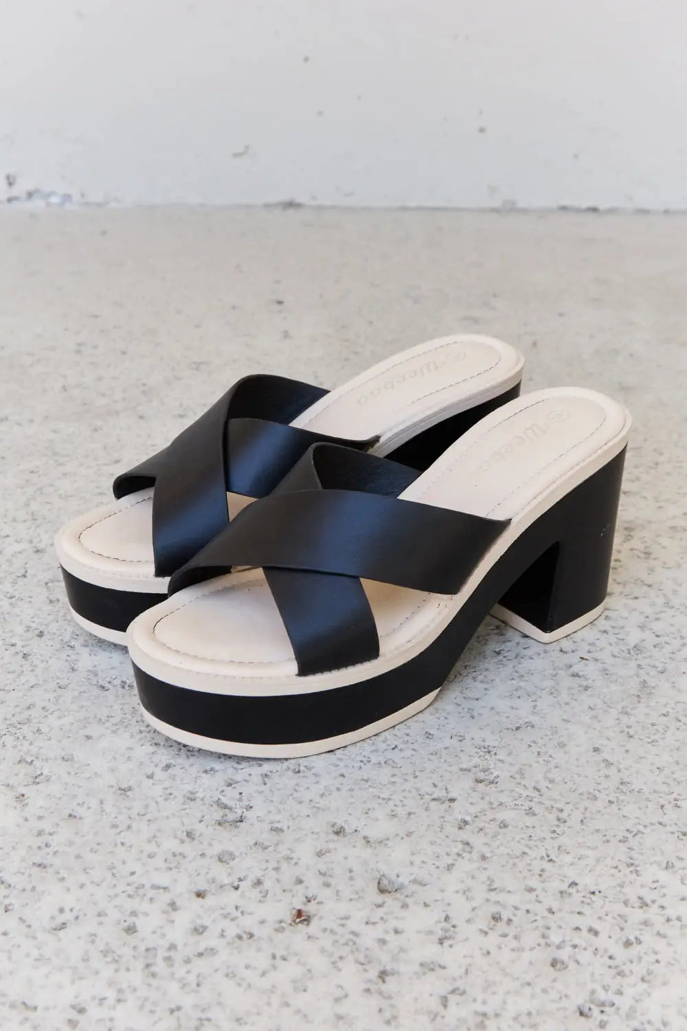 Black and white Weeboo Cherish platform sandals with crisscross straps and heel height