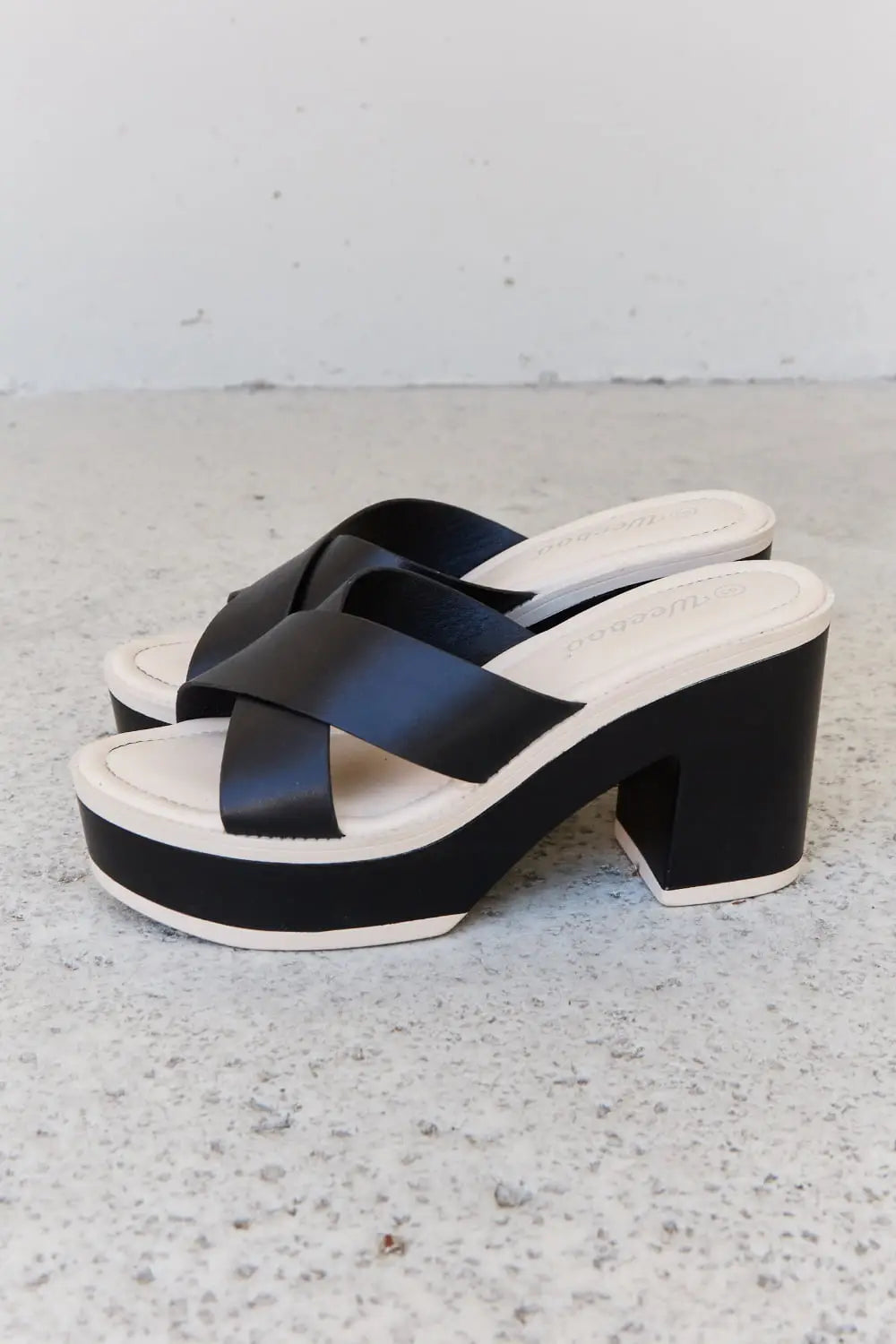 Black and white Weeboo Cherish platform sandals with crisscross straps and heel height