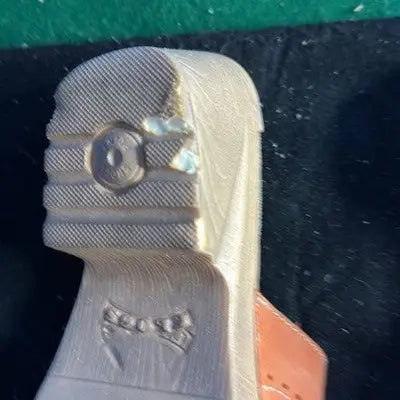 Partially constructed leather slide sandals heel with textured tread and bow design