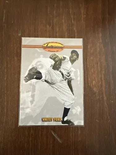 Whitey Ford baseball card featuring black and white pitcher image, gold oval, and nameplate