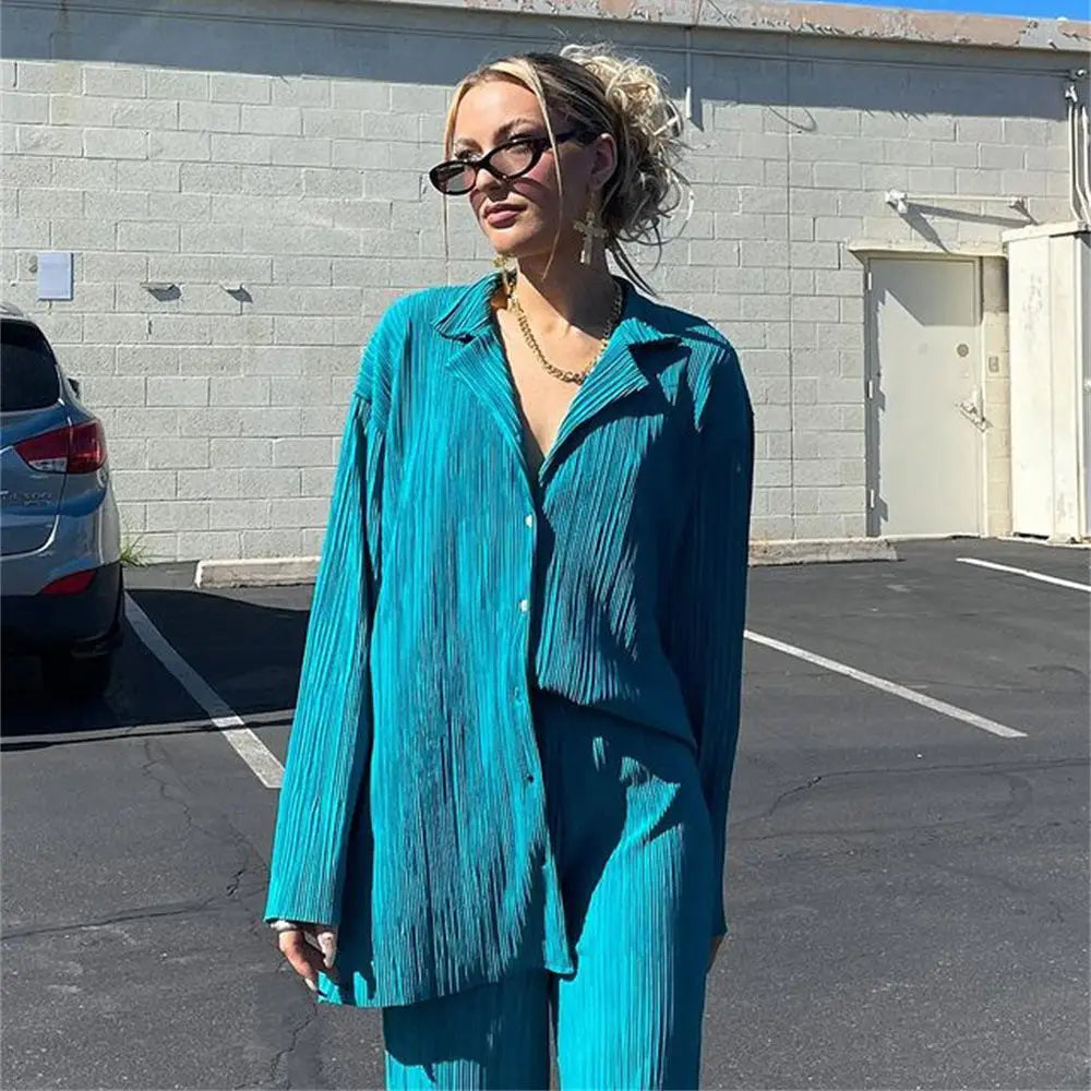 Women tracksuits shirt with long pants two-piece set worn by a woman in teal color