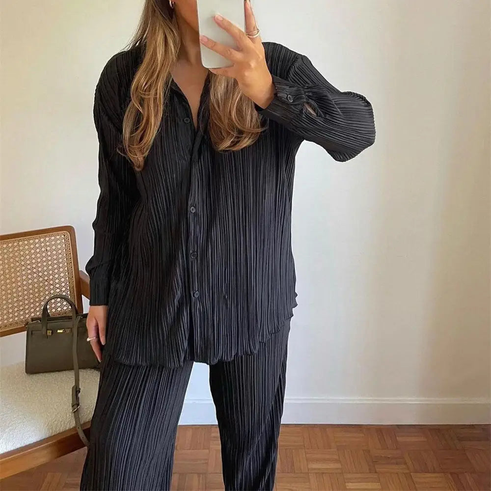 Women tracksuits shirt with long pants two-piece set worn by woman in stylish black pleated outfit