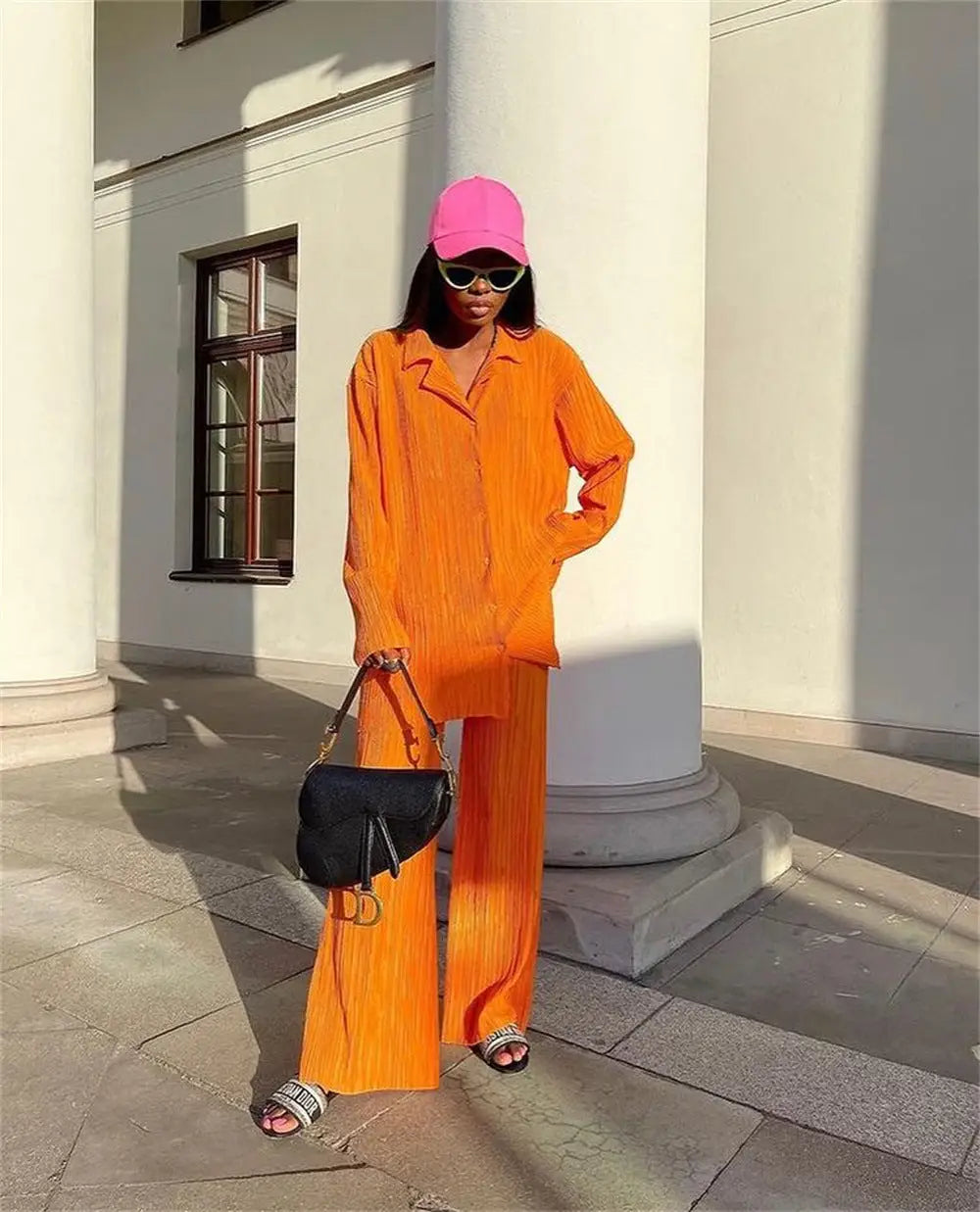 Stylish women tracksuits shirt with long pants two-piece outfit, hot pink cap, and accessories