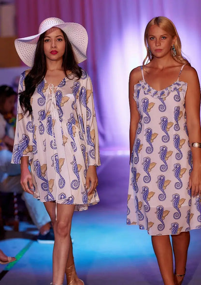 Women modeling white mini dress with blue and yellow seahorse flare sleeves