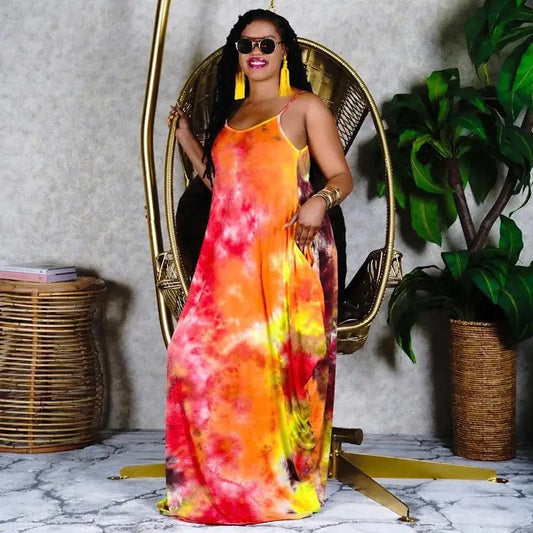 Woman in vibrant tie-dye casual long dress with spaghetti straps, perfect for fashion casual long style