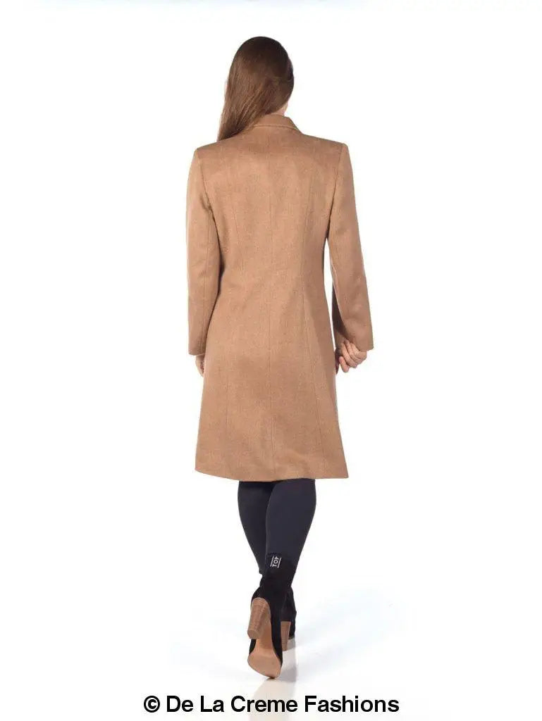 Woman wearing a camel-colored mohair blend longline winter coat, perfect for winter warmth