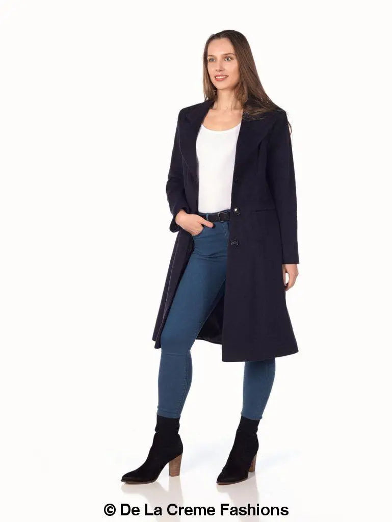 Woman wearing a mohair blend longline winter coat over a white top and blue jeans
