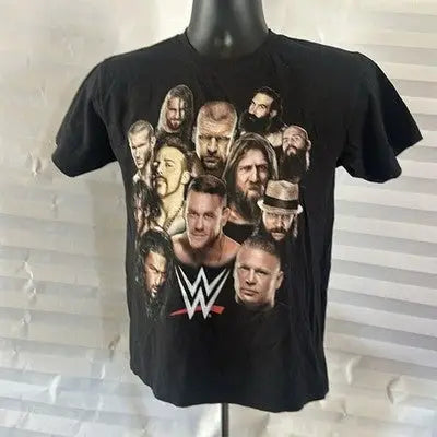 Black short sleeve WWE T-shirt featuring multiple wrestlers for boys size 10