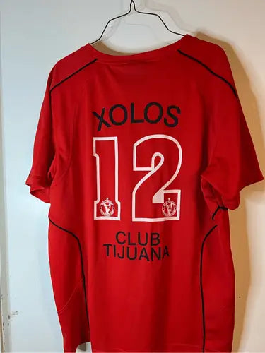 Red soccer jersey with black trim and white numbering for Xolos Soccer Jersey product