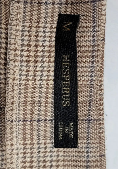 Black clothing tag on brown beige houndstooth fabric with blue plaid pattern for Y2K plaid mini skirt