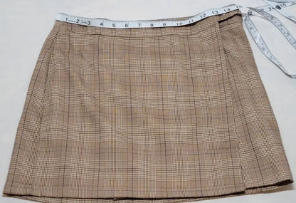 Y2K plaid mini skirt with measuring tape across waist, brown and white plaid design