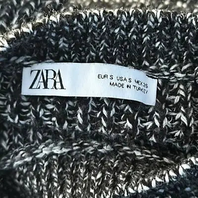 Black and white marled knit sweater with clothing label, size small, textured bodycon dress