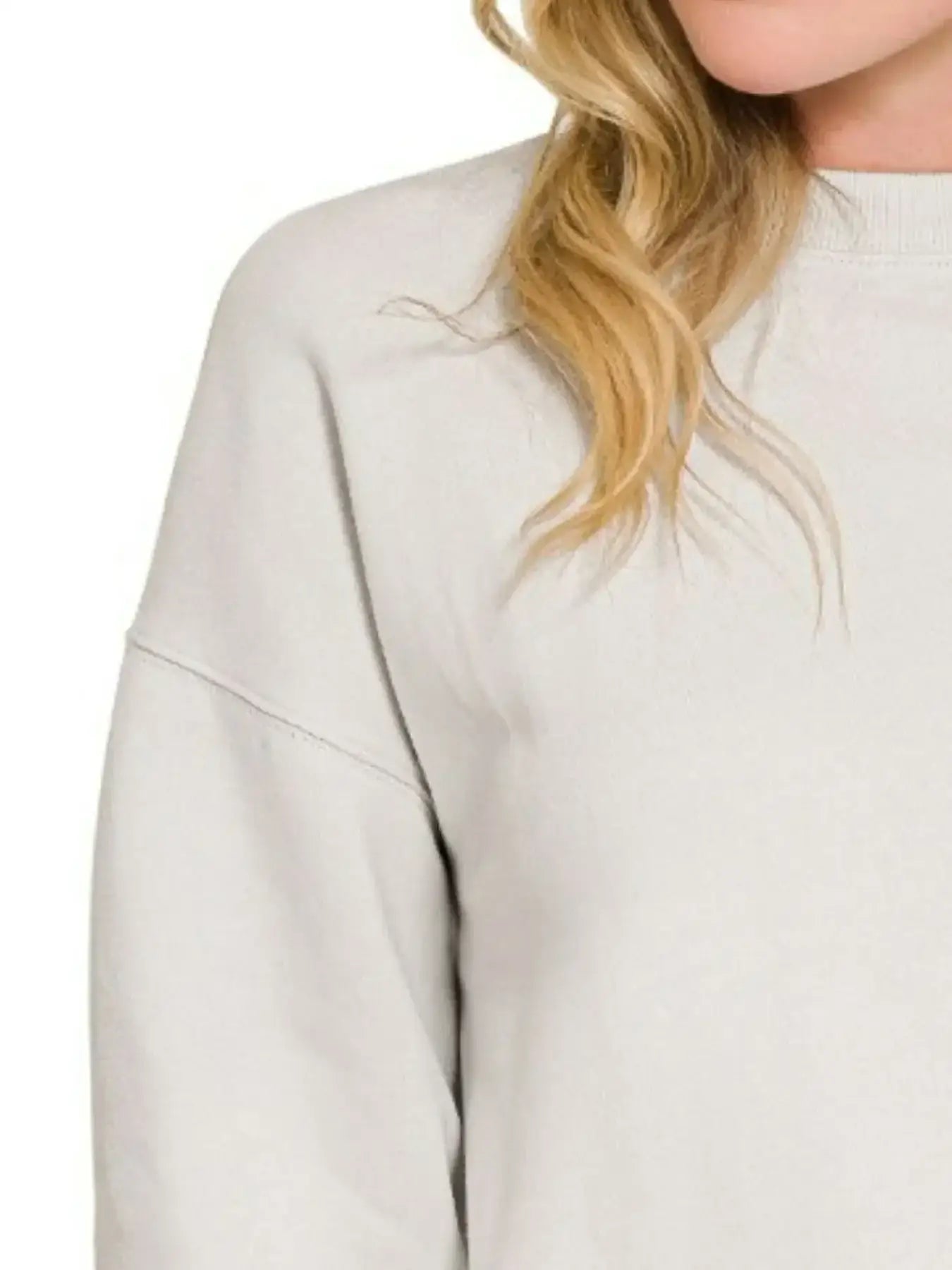 Cream-colored fleece crewneck sweatshirt with ribbed cuffs and hem for comfort