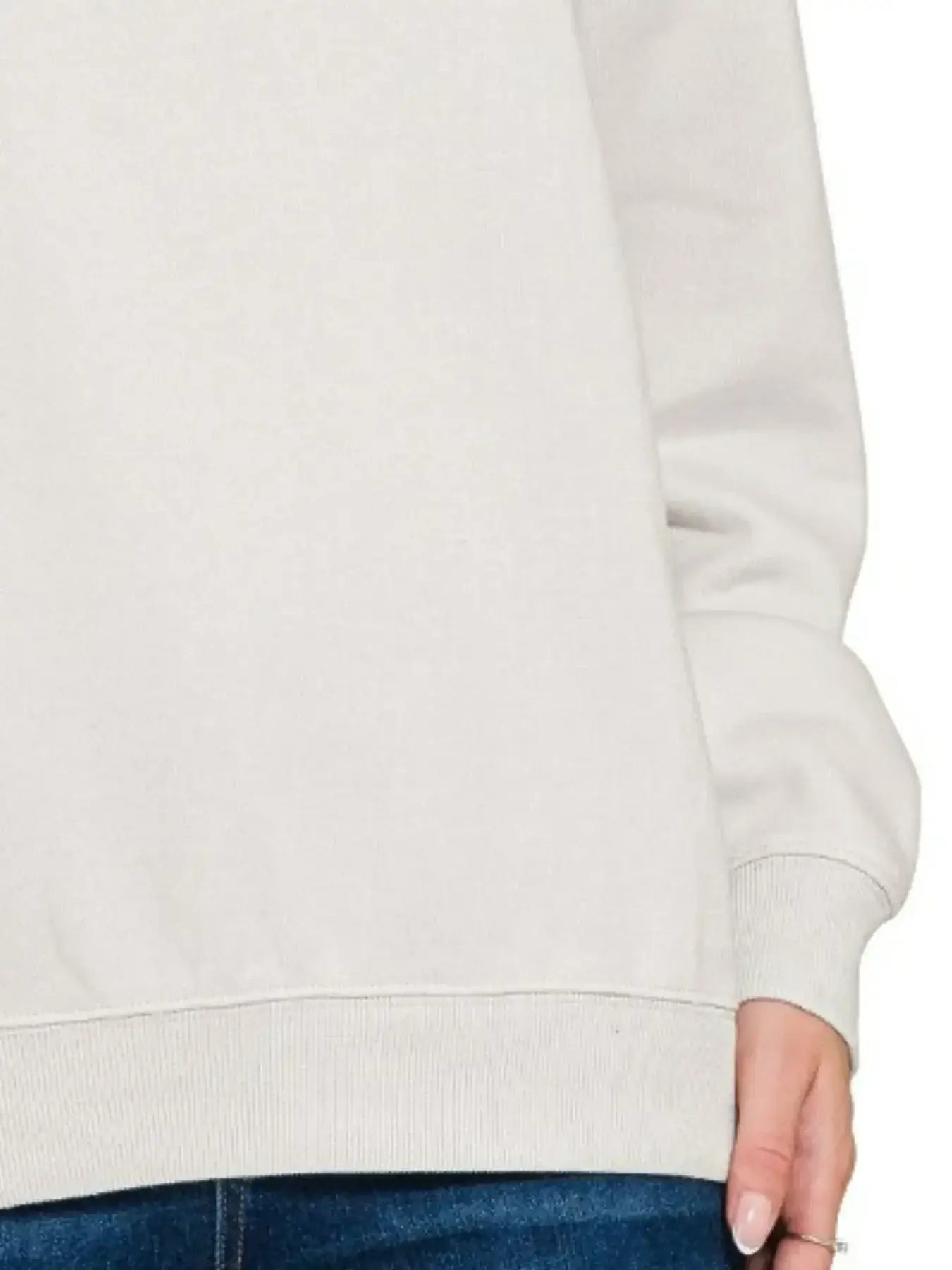 Cream-colored fleece crewneck long sleeve sweatshirt with ribbed cuffs and hem
