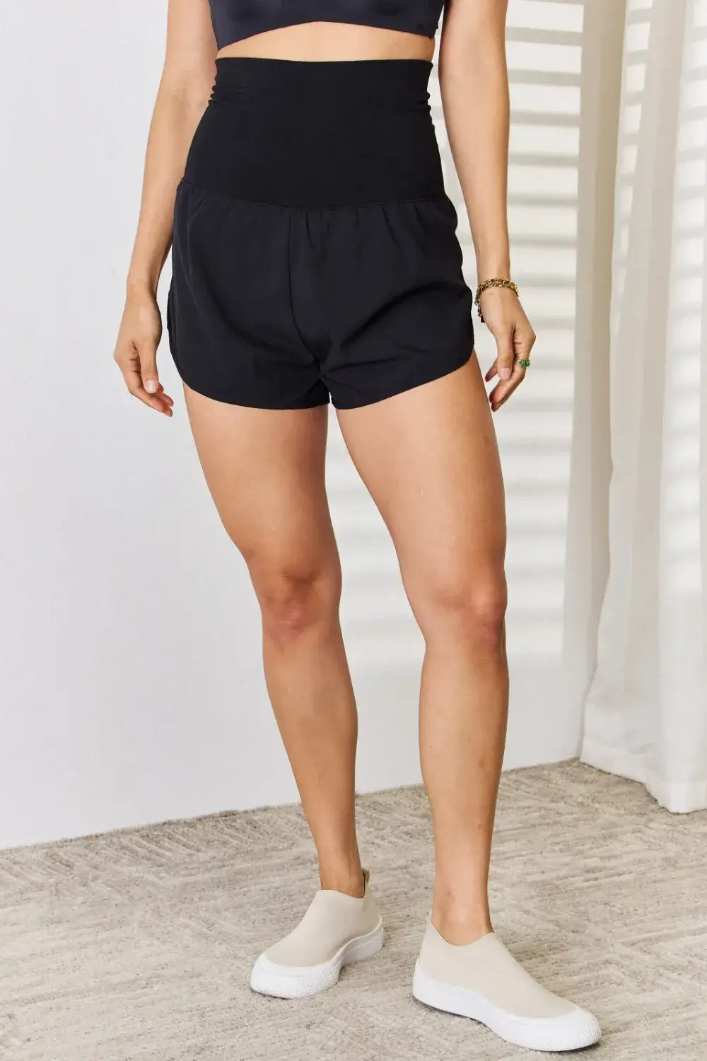 Black high-waisted tummy control athletic shorts with drawstring and side pockets