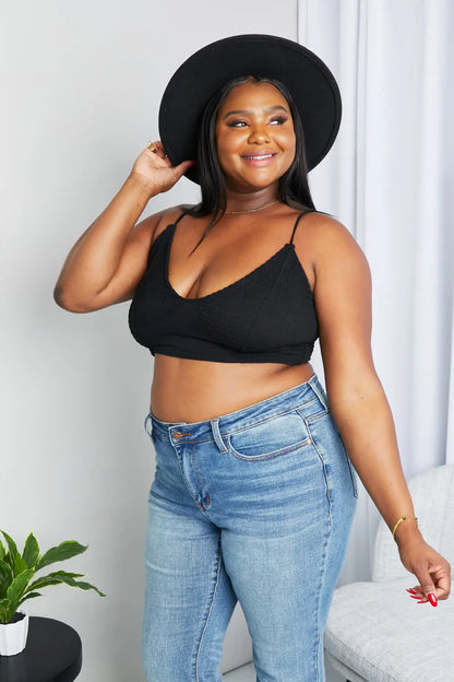 Black textured spaghetti strap bralette with thin straps and v-neck design