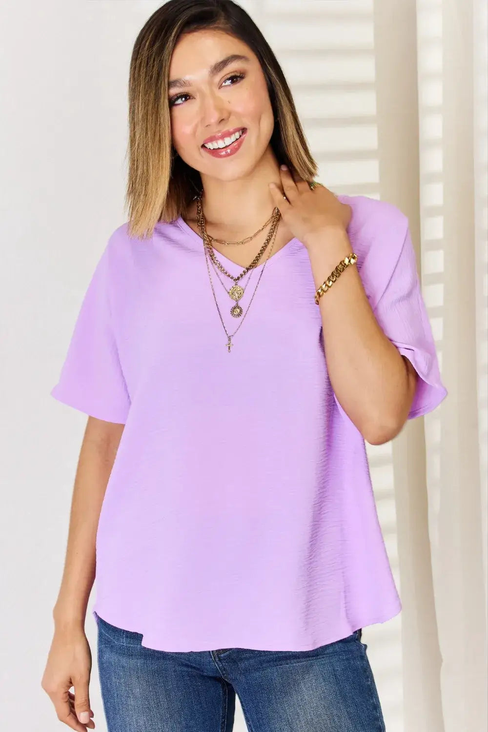Lavender ruffled sleeve blouse with layered necklaces and jeans, perfect for texture short sleeve style