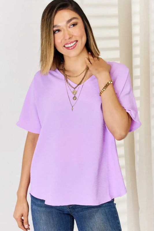 Lavender ruffled sleeve blouse with layered necklaces and jeans, perfect for texture short sleeve style