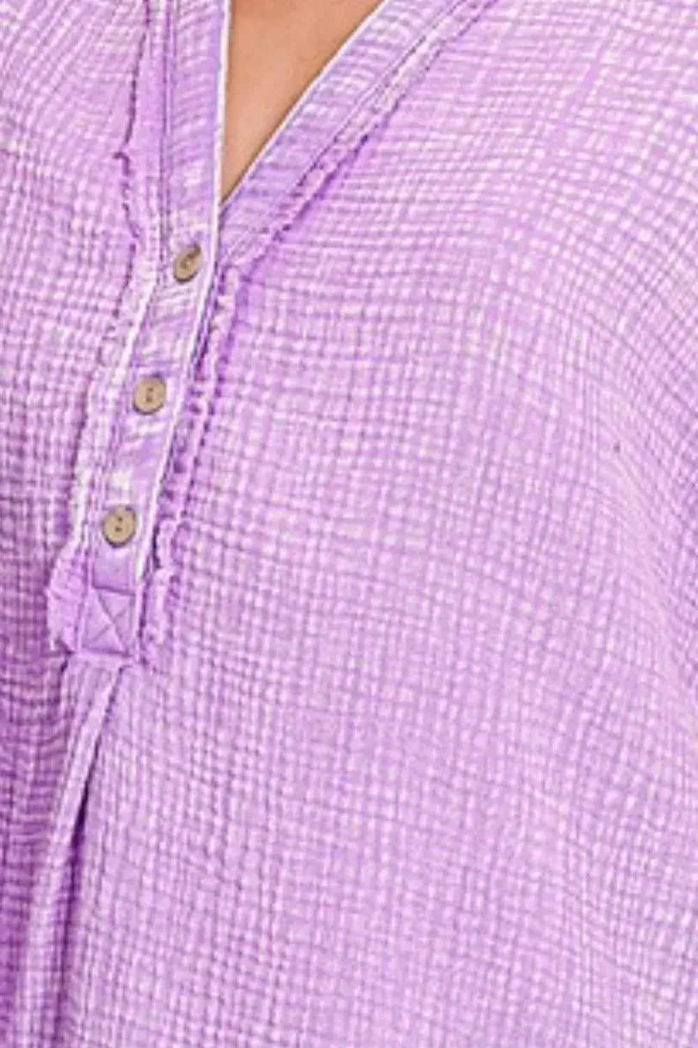 Lavender woven blouse with button front, ruffled hem, and henley neck in washed double gauze